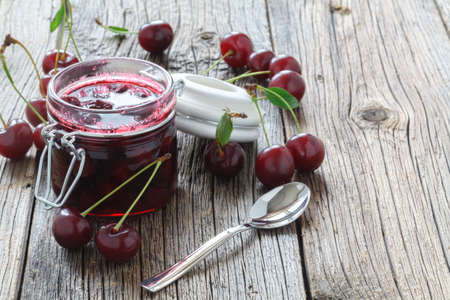 Cherry jam / cherry basket on wooden backgroundの写真素材