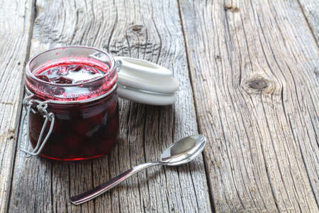 Cherry jam / cherry basket on wooden backgroundの写真素材