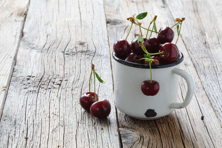 Cherries on wooden table with water drops macro backgroundの写真素材