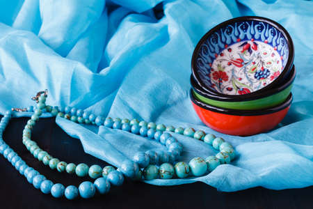 Strings of turquoise beads on blue silkの写真素材