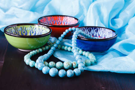 turquoise earrings on bowl. Fashion backgroundの写真素材