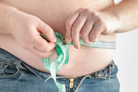 Man measuring belly