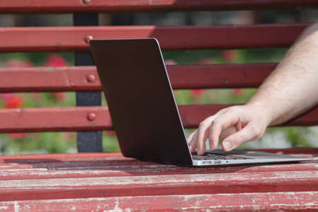 Close up view of open laptop on bench, freelance work conceptの写真素材