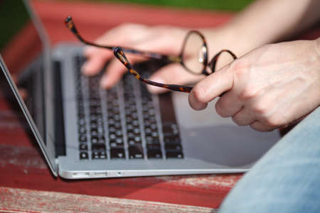 Young girl on a bench with a laptopの写真素材