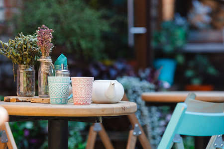 Coffee mug at the exit of the cafe . Coffee on the street, on the steps of the terrace at the entrance to the cafe .の写真素材