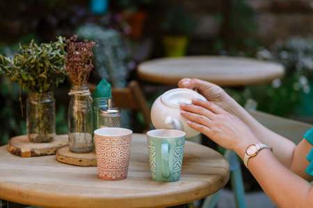 Woman are drinking tea in street cafeの写真素材