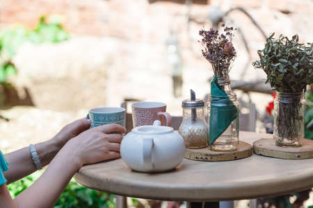 Woman are drinking tea in street cafeの写真素材