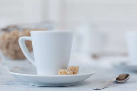 Photo coffee cup and sweets in a light key concept. still life in whiteの写真素材