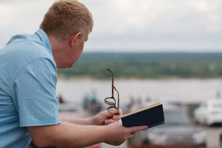Man reading book outdoor