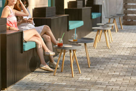 Young woman drink cold mojito cocktail at outdoor cafe