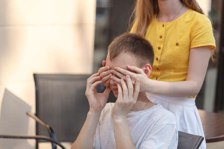 Woman covering boyfriends eyesの写真素材