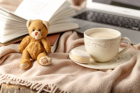 Cup of tea with book on table close-upの写真素材