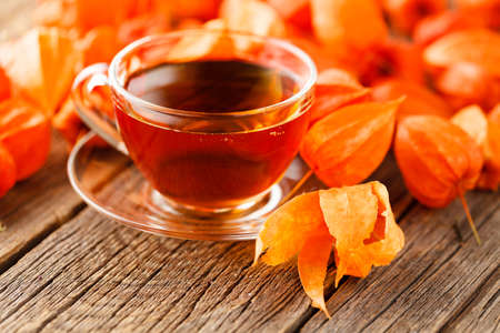 cup with hot drink on a wooden background autumnの写真素材
