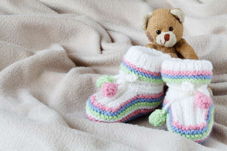 Newborn acessories, small shoes on soft backgroundの写真素材