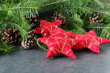 Christmas decoration with red stars on table with fir