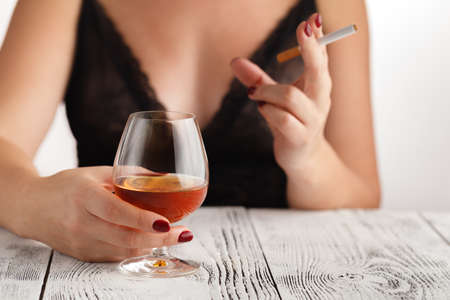 Woman alcoholism is social problem. Female drinking of  whiskey is cause of nervous stressの写真素材