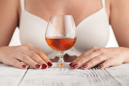 Beautiful young woman with cognacの写真素材