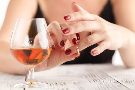 Woman Removes a Wedding Ring After The Divorceの写真素材