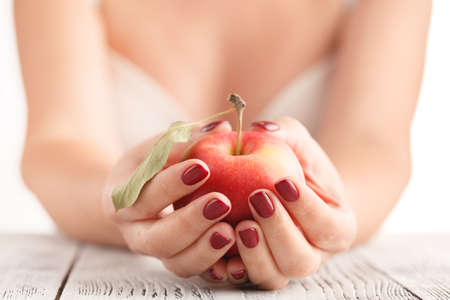 Attractive Female Holding Fruit Food Apple in Manicured Handsの写真素材