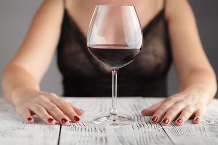 Young girl with glass of wineの写真素材