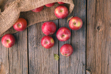 Heap of red apples in bulrap bagの写真素材