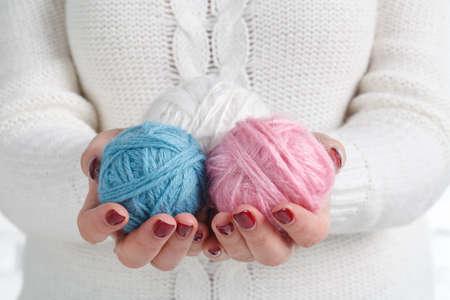 Hands holding a balls of yarnの写真素材