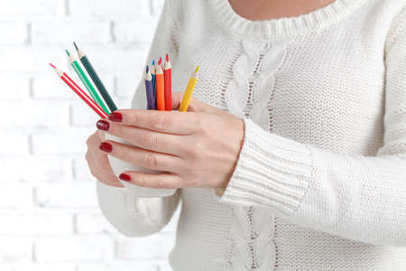Bunch of colored pencil in woman hands, art design conceptの写真素材