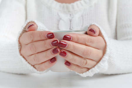 Hands holding mug of hot drink, close-upの写真素材