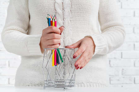 Bunch of colored pencil in woman hands, art design conceptの写真素材