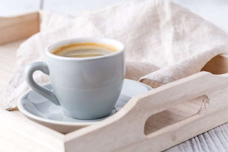 details of living room. Cup of coffee on rustic wooden trayの写真素材