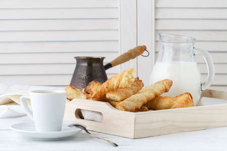 Cheese sticks with puff pastry on wooden tray. Delicious appetizer