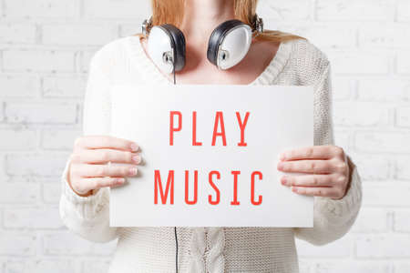 people, leisure and technology concept - happy woman or teenage girl in headphones listening to...