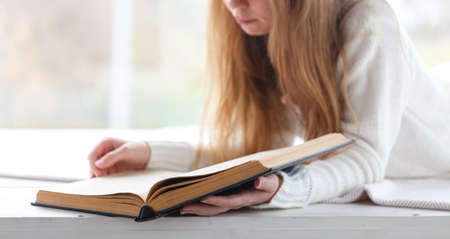Blond woman reading bookの写真素材