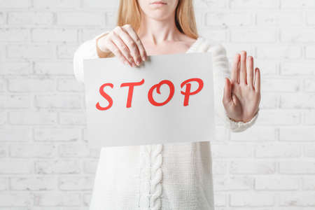 teenage girl in casual clothes holding sheet of paperの写真素材