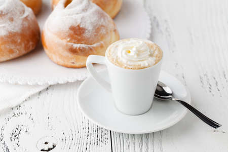 Breakfast with cappuccino and croissant
