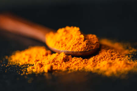 Saffron in a spoon on a dark background, selective focus, macro shot, shallow depth of fieldの写真素材