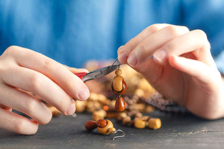 Free time evening making beads. Woman leisure home work hobbyの写真素材