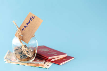 Travel budget concept. Travel money savings in a glass jarの写真素材