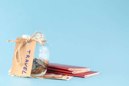 Travel budget concept. Travel money savings in a glass jarの写真素材
