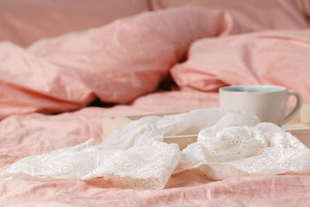 Fresh morning coffee on tray in the bed. Lifestyle Concept