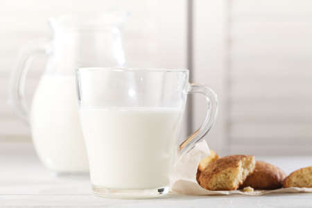 Freshly baked snickerdoodle cookies  with old-fashioned milk jug. Closeup with soft, natural side lighting.の写真素材