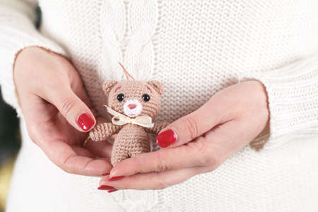 woman holds soft toy bearの写真素材