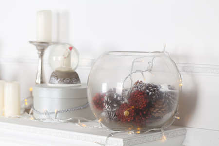 Fireplace mantle decorated with candles and garlands for Christmasの写真素材