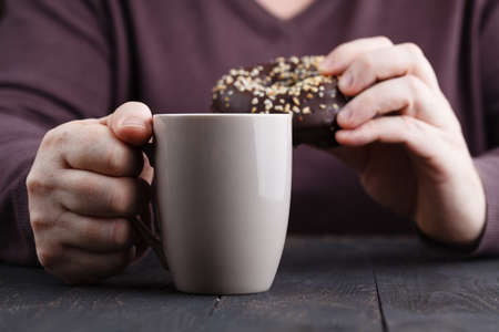 man eating chocolate donut