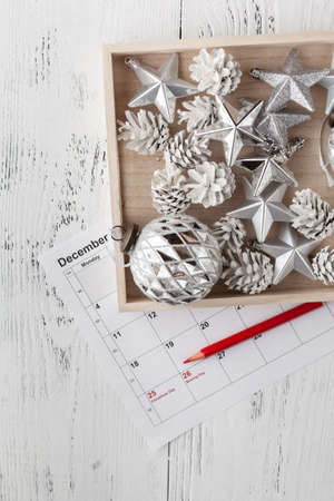 Christmas calendar. Christmas gift, fir branches on wooden white background. Copy space, top view.