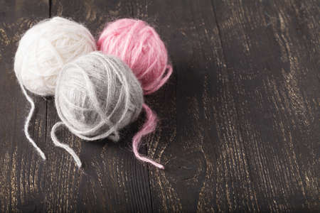 Balls of wool on wooden table
