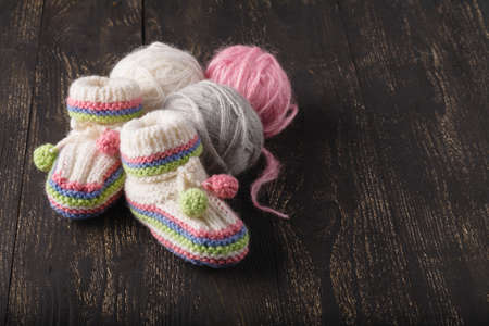 Knitting baby shoes with multicolor yarnの写真素材