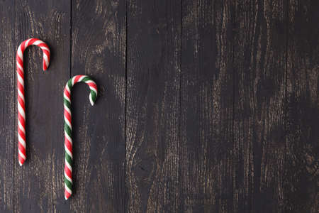 Candy canes on wooden boards - holidays background