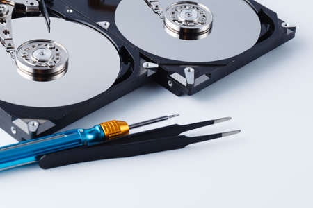repair hard drive concept on white background with tools