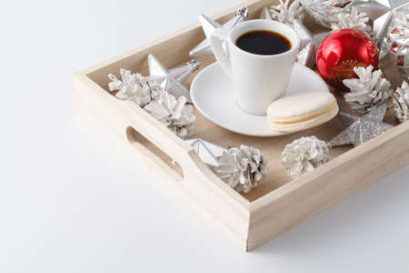 Christmas decoration and small cup of coffee on white